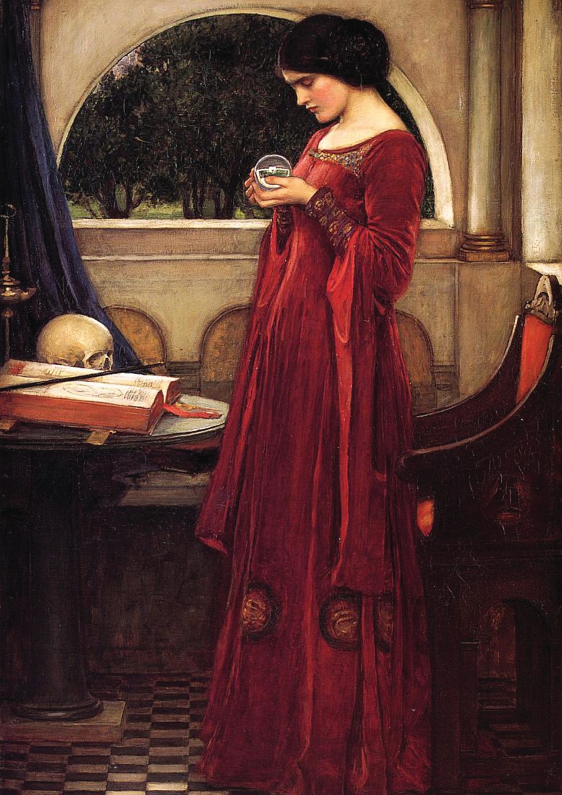 The Crystal Ball by John William Waterhouse, 1902. A woman in a long red gown gazes into a crystal ball beside a table holding an open book and a skull.