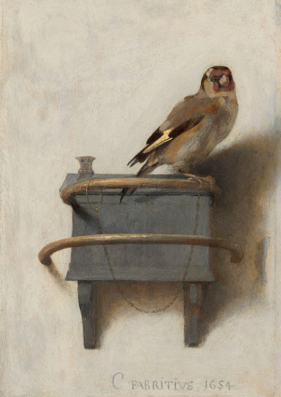 The Goldfinch by Carel Fabritius, 1654. A small goldfinch perches on a wooden feeder box fixed to a pale plaster wall, with a fine chain around its leg.