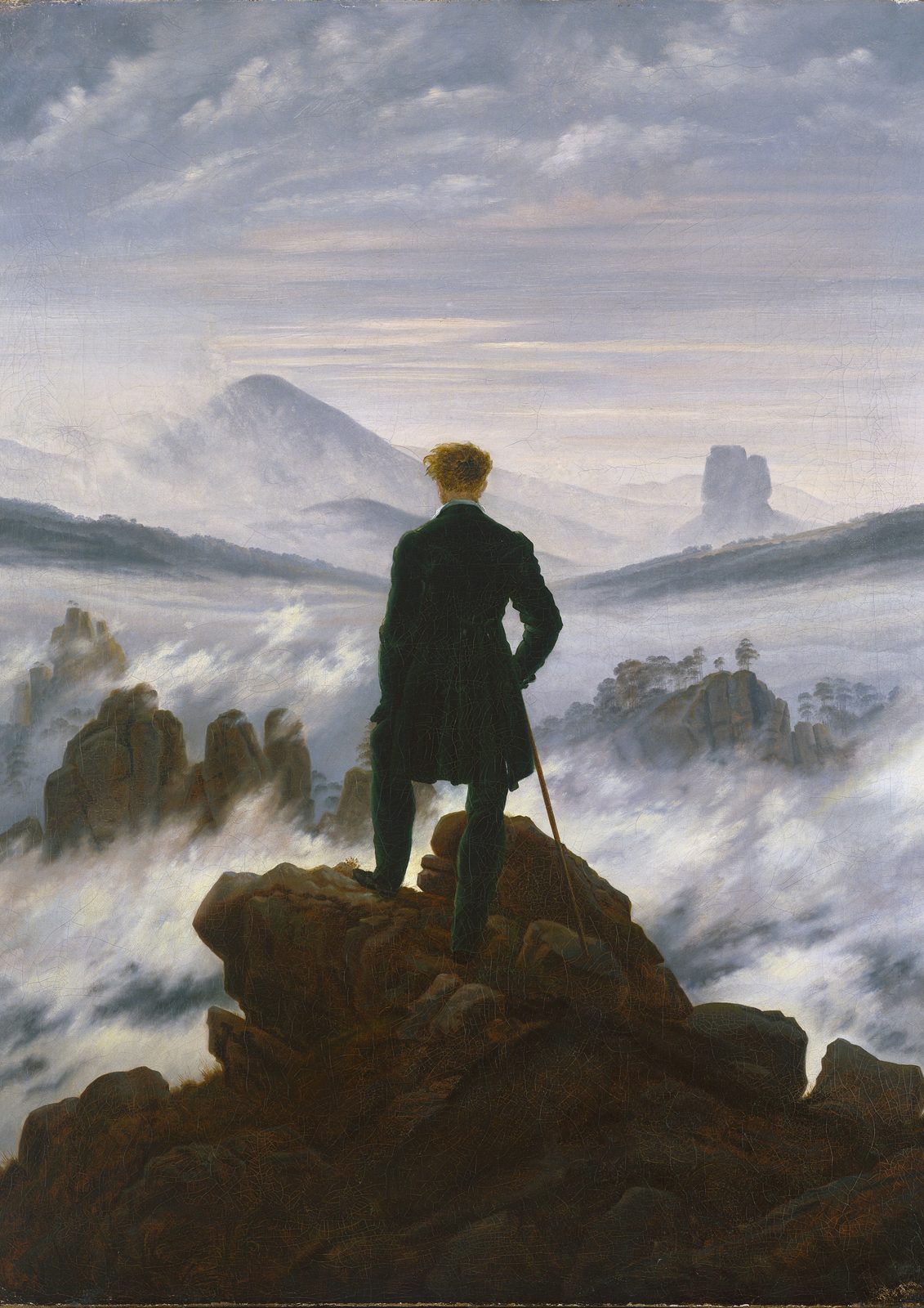 Wanderer above the Sea of Fog by Caspar David Friedrich, around 1818. A man in a dark coat stands on a rocky summit with his back turned, looking out over a sea of mist and distant mountains.